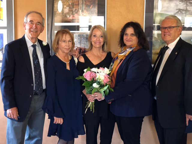 Rita Shulak holds flowers given to her at the vernissage. She is shown here with Mayor Hall & Phyllis and Tom & Tonya Hersant. 